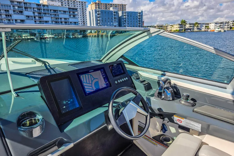  Yacht Photos Pics Cockpit of 2022 Aviara AV32 OB boat with modern navigation system and steering wheel.