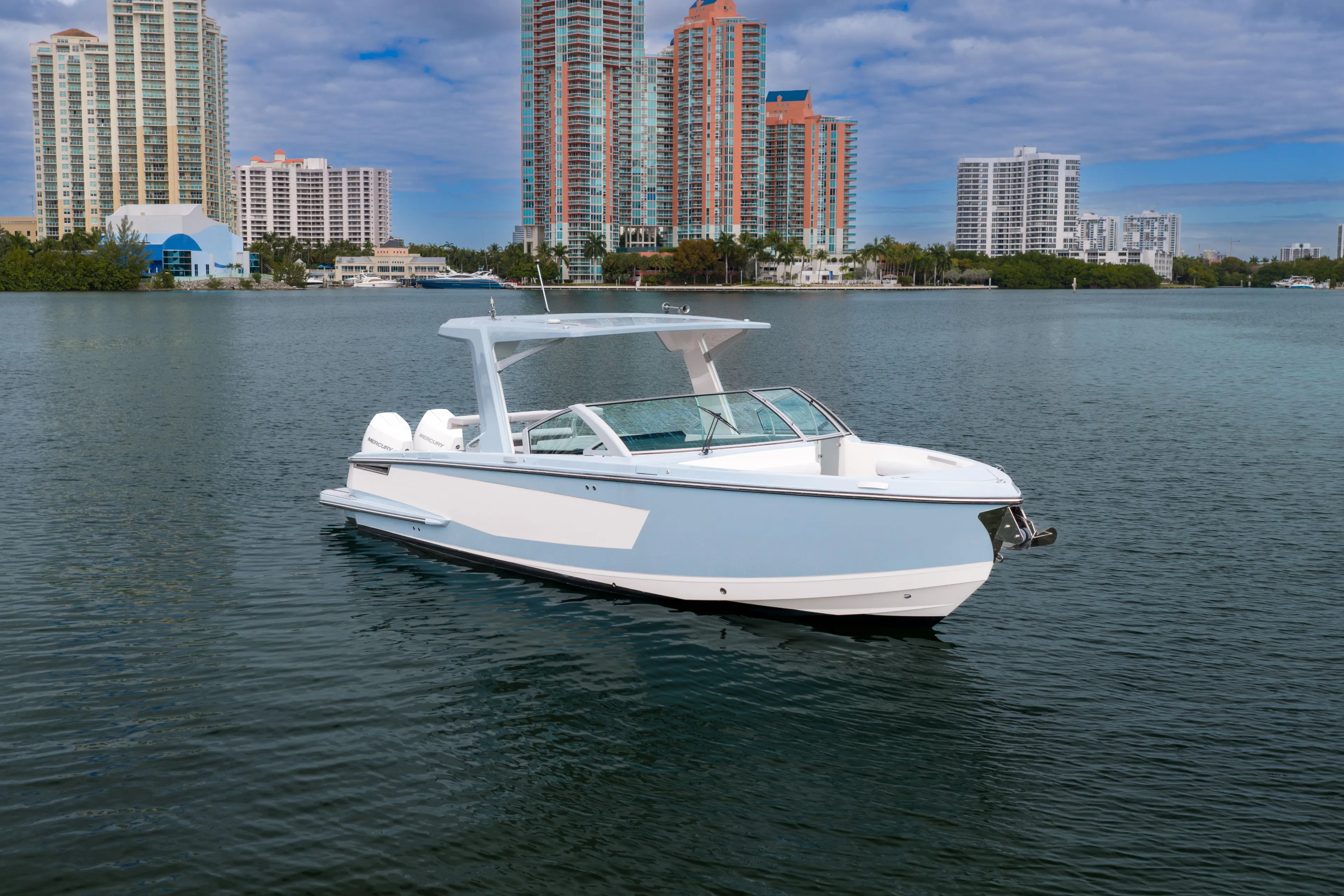  Yacht Photos Pics 2022 Aviara AV32 OB boat on water with city skyline background.