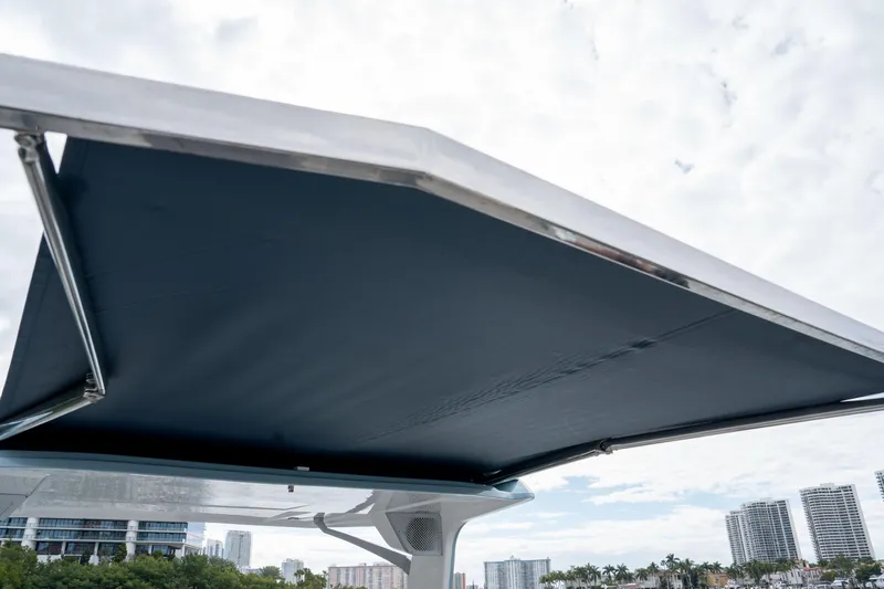  Yacht Photos Pics 2022 Aviara AV32 OB boat canopy with city skyline in background.