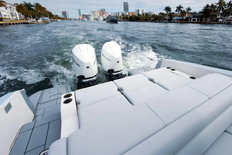  Yacht Photos Pics 2022 Aviara AV32 OB boat with dual Mercury outboard engines cruising on a scenic waterway.