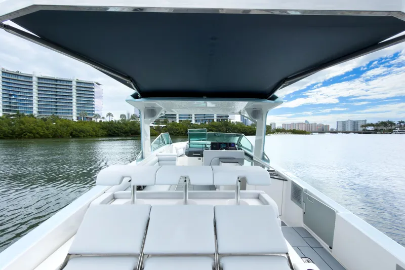  Yacht Photos Pics 2022 Aviara AV32 OB boat with luxurious seating, cruising on a scenic waterway.