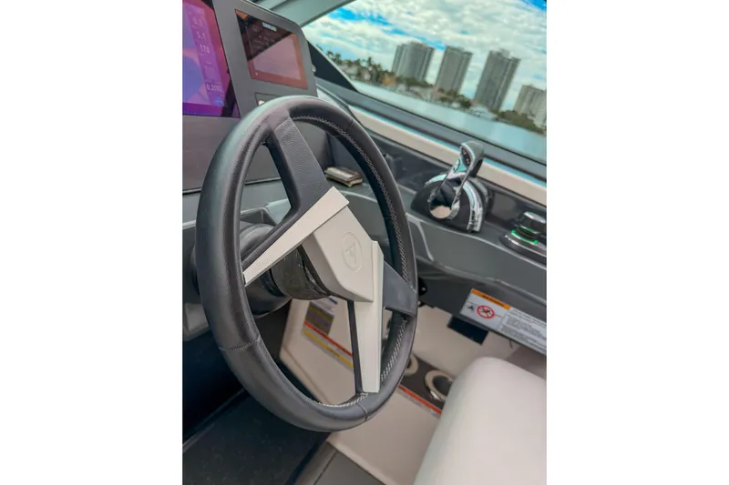  Yacht Photos Pics Steering wheel of 2022 Aviara AV32 OB boat with modern dashboard controls.