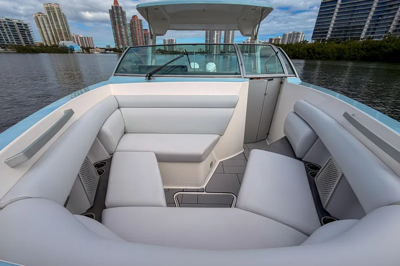  Yacht Photos Pics 2022 Aviara AV32 OB boat interior with white seating, city skyline in background.