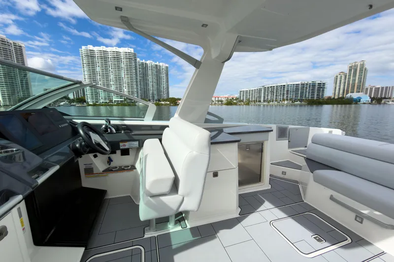  Yacht Photos Pics 2022 Aviara AV32 OB boat interior with modern seating and cityscape view.