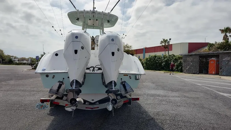  Yacht Photos Pics 2023 Cape Horn 27 XS boat with dual outboard engines, parked on a sunny day.