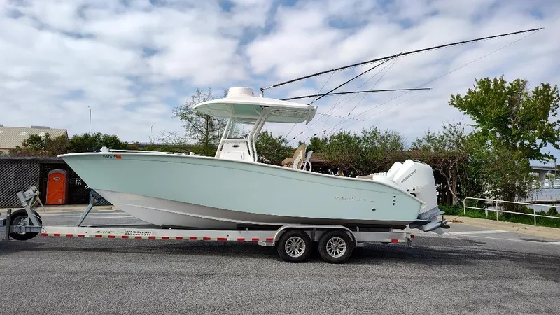  Yacht Photos Pics 2023 Cape Horn 27 XS boat on trailer, parked outdoors under cloudy sky.