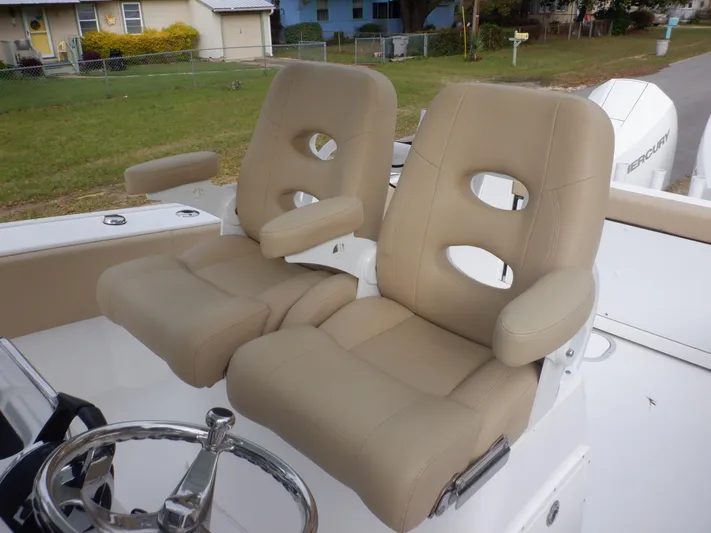  Yacht Photos Pics 2023 Cape Horn 27 XS boat with beige cushioned seats and steering wheel.