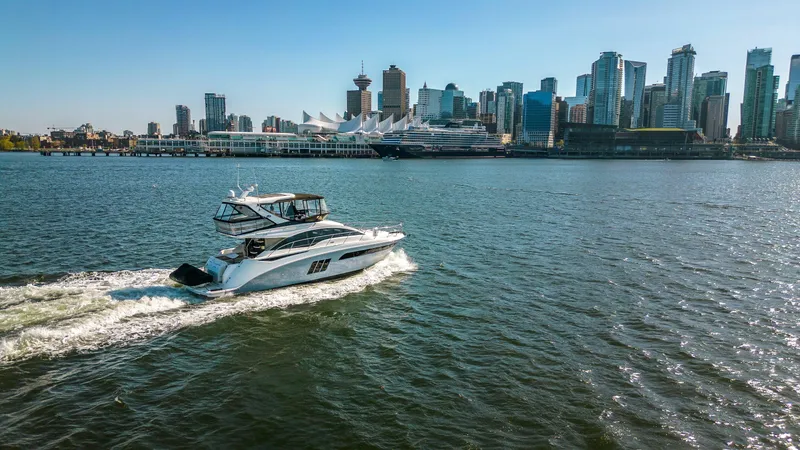 Waterfront III Yacht Photos Pics Sea Ray 510 Fly yacht cruising near city skyline, 2014 model.