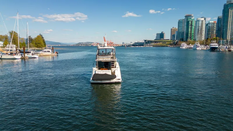 Waterfront III Yacht Photos Pics Sea Ray 510 Fly yacht on water with city skyline and boats in background.