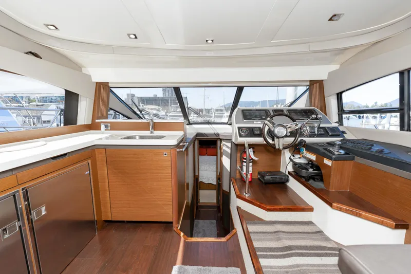 Waterfront III Yacht Photos Pics Luxurious interior of 2014 Sea Ray 510 Fly yacht with modern helm and kitchen area.