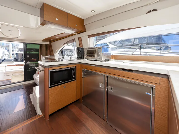 Waterfront III Yacht Photos Pics Luxurious 2014 Sea Ray 510 Fly yacht kitchen with modern appliances and sleek wood finishes.