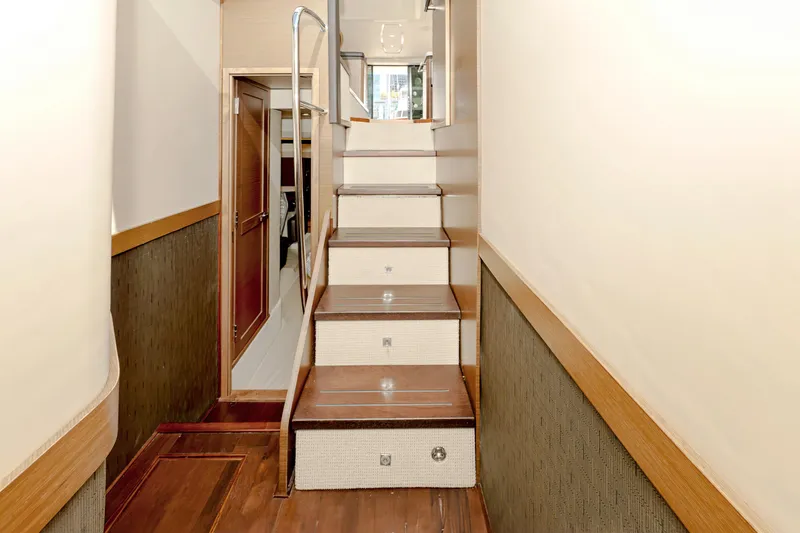 Waterfront III Yacht Photos Pics Interior staircase of 2014 Sea Ray 510 Fly yacht, featuring wooden steps and modern design.