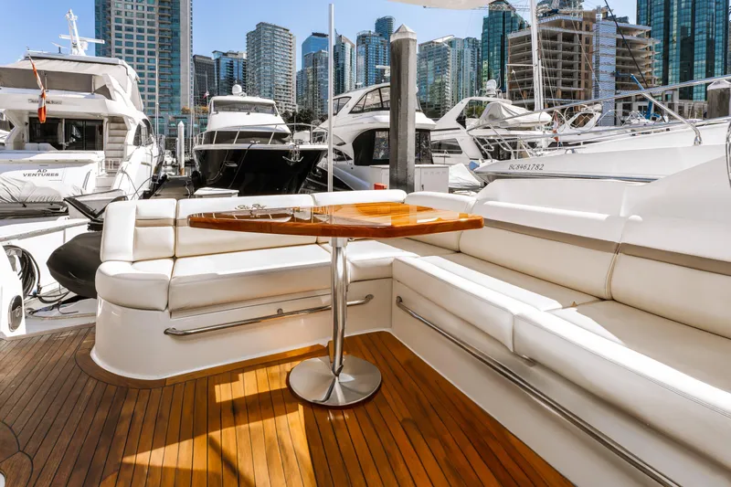 Waterfront III Yacht Photos Pics Luxurious 2014 Sea Ray 510 Fly yacht with elegant seating and wooden deck in a marina.