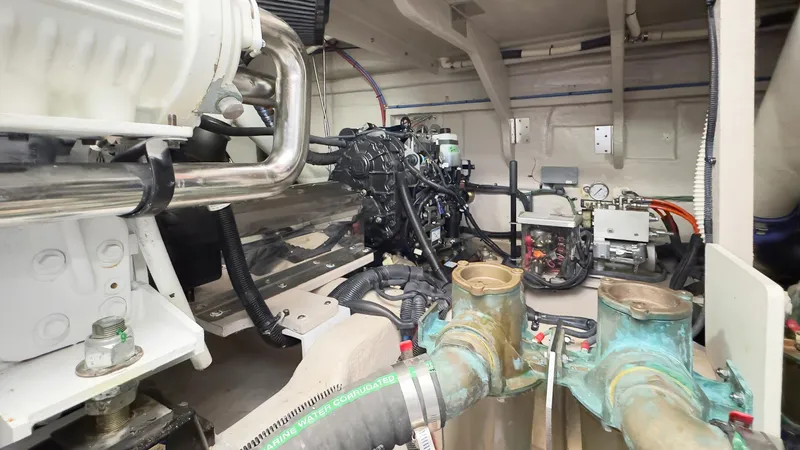 Waterfront III Yacht Photos Pics Engine room of 2014 Sea Ray 510 Fly yacht, showcasing mechanical components and piping.