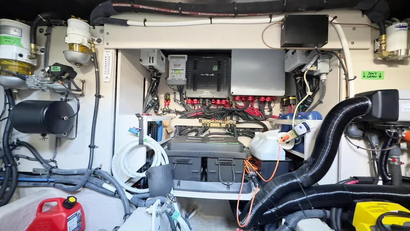 Waterfront III Yacht Photos Pics Engine room of a 2014 Sea Ray 510 Fly, showcasing electrical components and wiring.