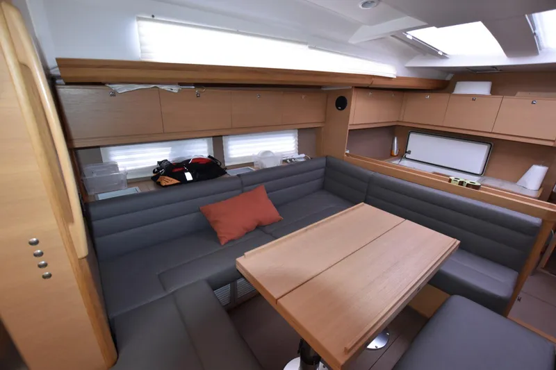 Gypsy Yacht Photos Pics Interior of 2015 Dufour 500 Grand Large yacht with modern seating and wooden table.