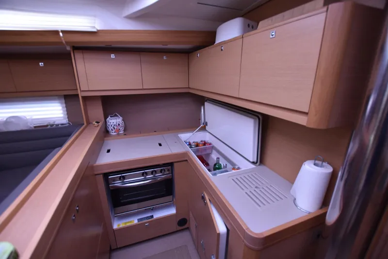 Gypsy Yacht Photos Pics 2015 Dufour 500 Grand Large yacht kitchen with modern appliances and wooden cabinetry.