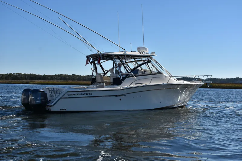  Yacht Photos Pics 2017 Grady-White Express 330 boat on calm water under clear blue sky.