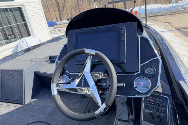 2026 Vexus VXs20 boat dashboard with steering wheel and digital display.