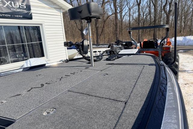 2026 Vexus VXs20 boat deck with equipment, parked near a snowy wooded area.