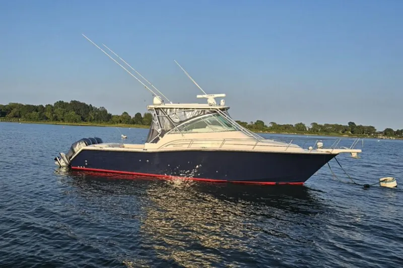 Yacht Photos Pics 2008 Grady-White Express 360 boat anchored on calm water, clear sky background.
