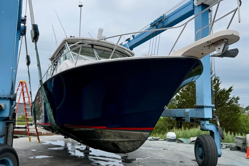  Yacht Photos Pics 2008 Grady-White Express 360 boat on lift, blue hull, marina setting.