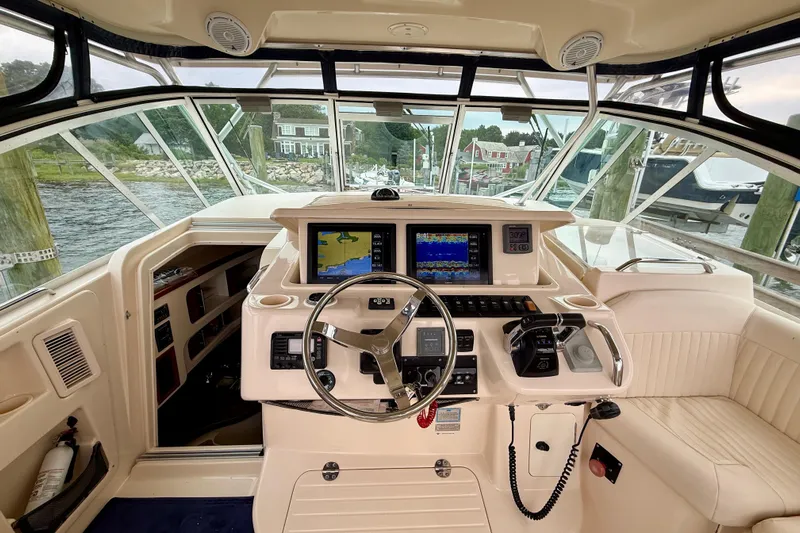  Yacht Photos Pics 2008 Grady-White Express 360 helm with navigation screens and steering wheel, docked by the water.