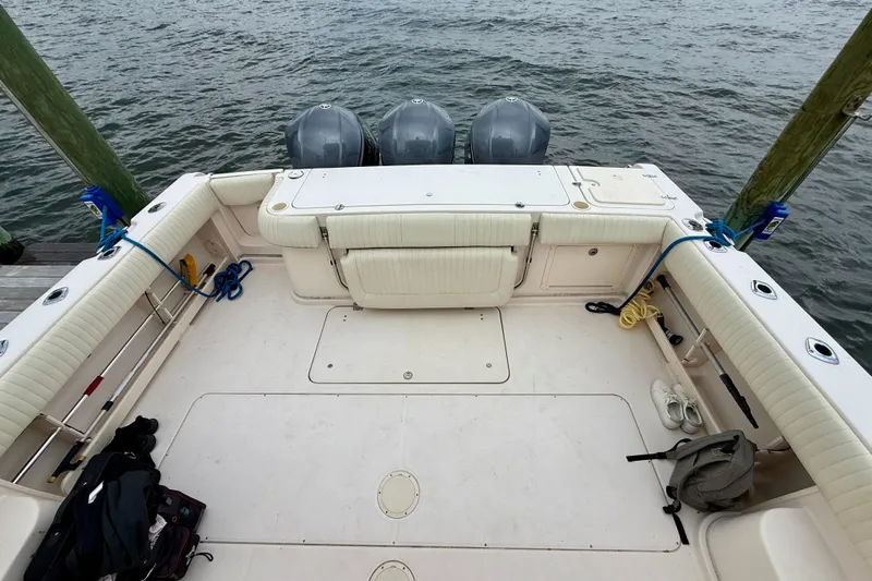  Yacht Photos Pics 2008 Grady-White Express 360 boat deck with triple outboard motors, docked by the water.