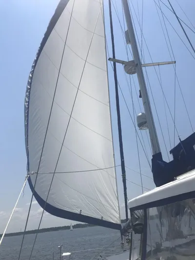 Adventure Yacht Photos Pics Sailing on a 2010 Broadblue 435 catamaran with full sails under a clear blue sky.