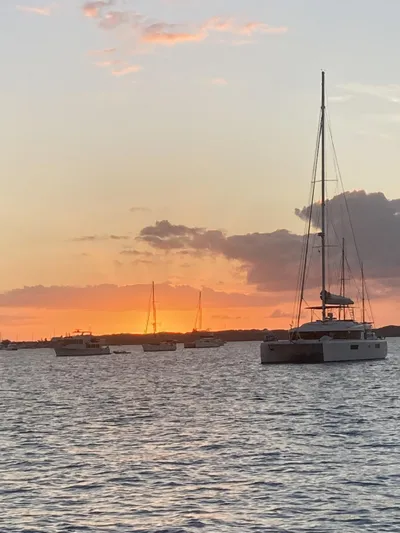Adventure Yacht Photos Pics Sailboats on tranquil water at sunset, featuring a 2010 Broadblue 435 catamaran.