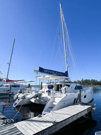 Adventure Yacht Photos Pics 2010 Broadblue 435 catamaran docked at marina under clear blue sky.