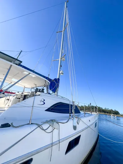 Adventure Yacht Photos Pics 2010 Broadblue 435 catamaran docked on calm water under clear blue sky.