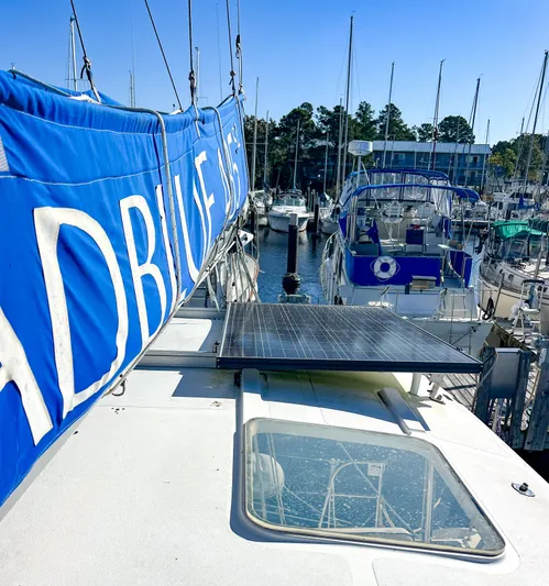 Adventure Yacht Photos Pics Broadblue 435 catamaran docked, featuring solar panel and blue sail cover, 2010 model.