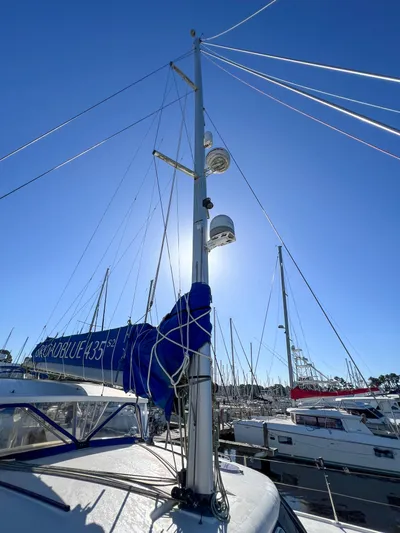 Adventure Yacht Photos Pics Sailboat mast of a 2010 Broadblue 435 catamaran under clear blue sky.