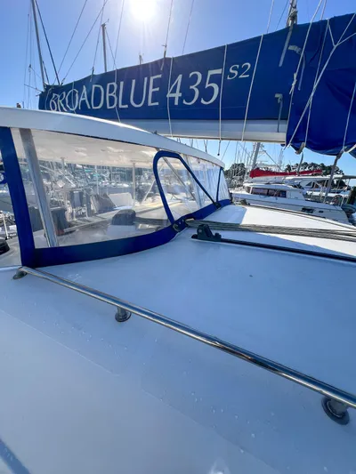 Adventure Yacht Photos Pics 2010 Broadblue 435 sailboat with blue sail cover, docked in marina under clear sky.