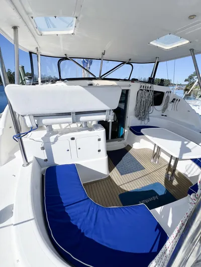 Adventure Yacht Photos Pics 2010 Broadblue 435 catamaran cockpit with blue seating, white table, and nautical decor.