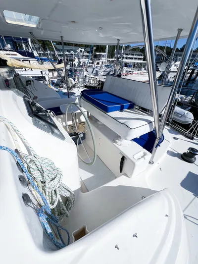 Adventure Yacht Photos Pics 2010 Broadblue 435 yacht cockpit with seating, steering wheel, and marina view.