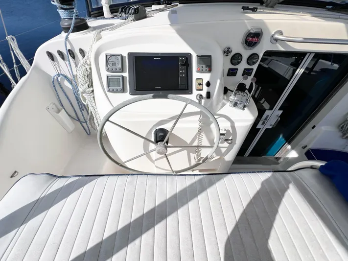 Adventure Yacht Photos Pics Helm of 2010 Broadblue 435 catamaran with steering wheel and navigation instruments.