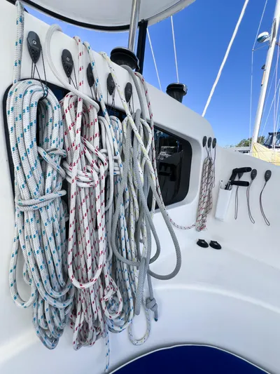Adventure Yacht Photos Pics Sailing ropes on a 2010 Broadblue 435 catamaran, neatly organized against a clear blue sky.