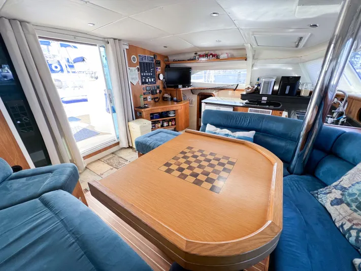 Adventure Yacht Photos Pics Luxurious interior of 2010 Broadblue 435 catamaran with chess table and cozy seating area.