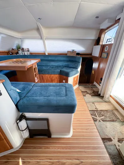 Adventure Yacht Photos Pics Interior of 2010 Broadblue 435 catamaran with blue seating and wooden flooring.