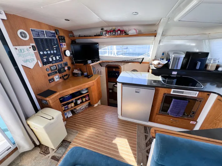 Adventure Yacht Photos Pics Interior of 2010 Broadblue 435 catamaran with kitchen, control panel, and seating area.