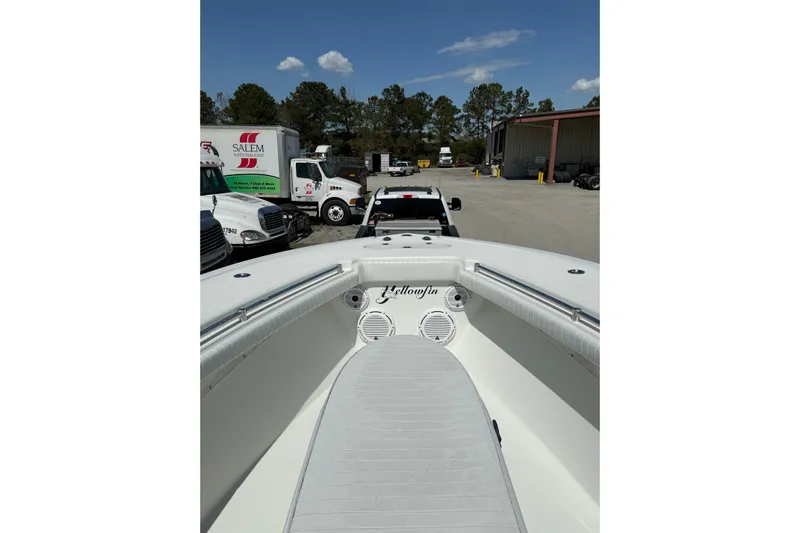 Cut Loose Yacht Photos Pics 2013 Yellowfin 32 Offshore boat on trailer, parked near trucks and warehouse.