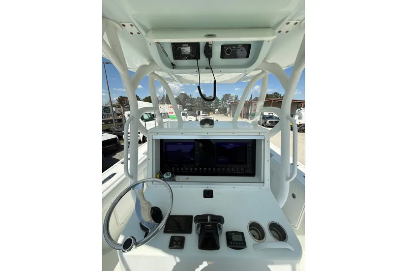 Cut Loose Yacht Photos Pics 2013 Yellowfin 32 Offshore boat dashboard with steering wheel and navigation equipment.