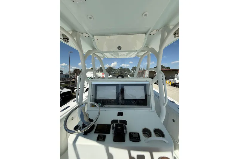 Cut Loose Yacht Photos Pics 2013 Yellowfin 32 Offshore boat dashboard with steering wheel and navigation screens.