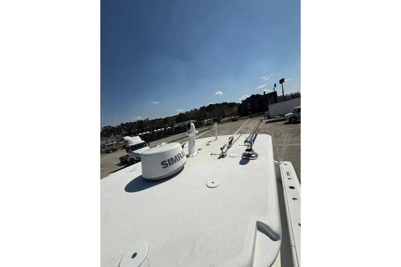 Cut Loose Yacht Photos Pics 2013 Yellowfin 32 Offshore boat with Simrad equipment on deck, parked outdoors.