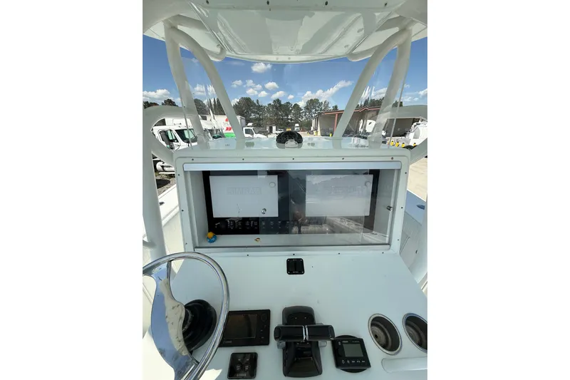 Cut Loose Yacht Photos Pics 2013 Yellowfin 32 Offshore boat dashboard with steering wheel and navigation equipment.