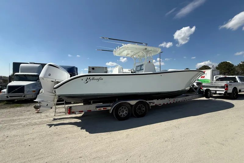 Cut Loose Yacht Photos Pics 2013 Yellowfin 32 Offshore boat on trailer under clear blue sky.