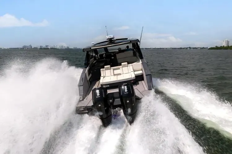  Yacht Photos Pics 2023 Cruisers 42 GLS OB speeding on open water, showcasing powerful outboard engines.