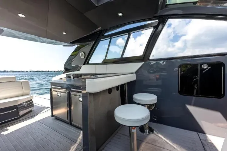  Yacht Photos Pics Luxurious 2023 Cruisers 42 GLS OB yacht interior with bar stools and scenic water view.